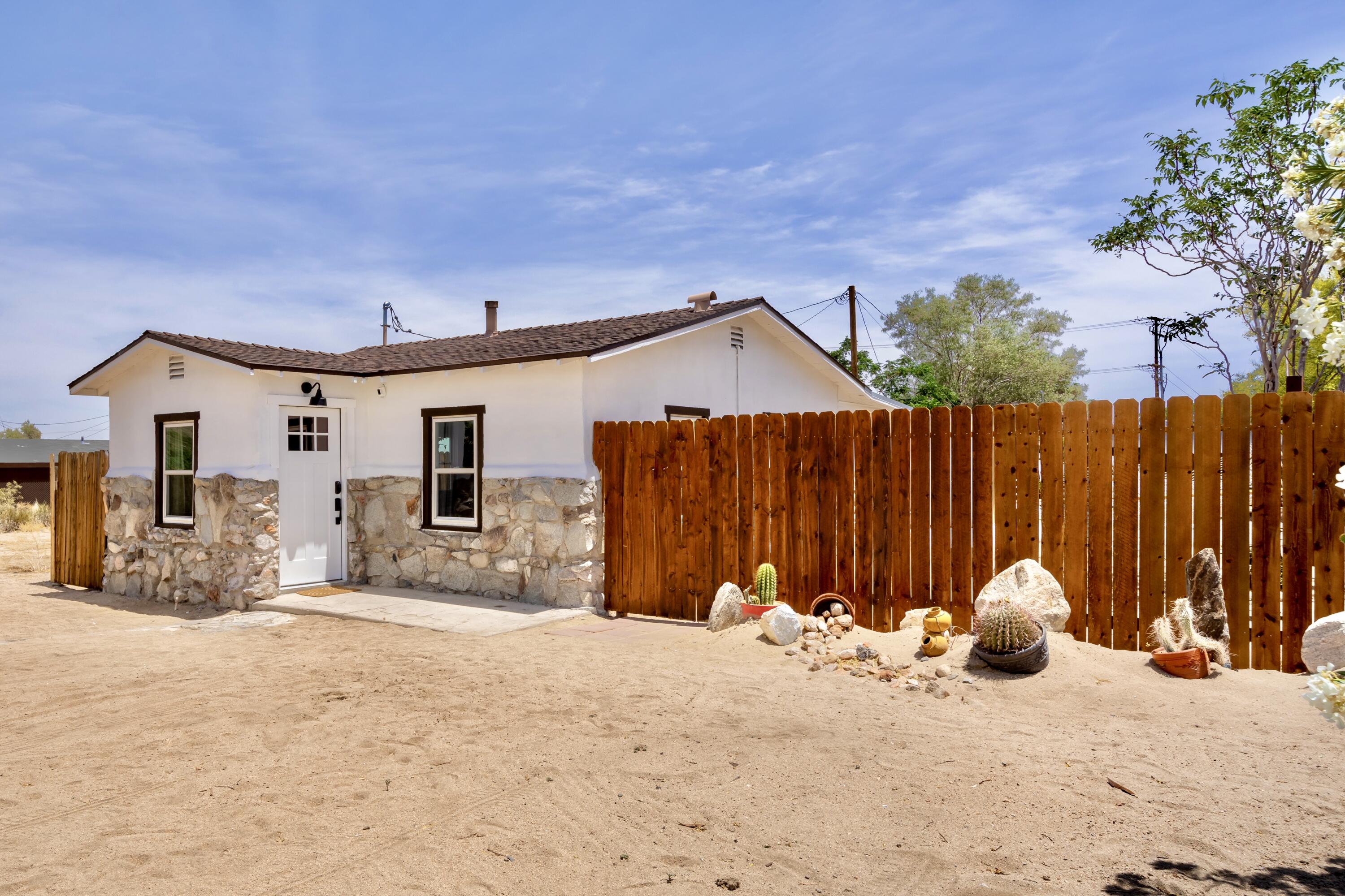 a view of a house with wooden walls and a yard