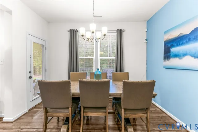 a living room with fireplace furniture and a chandelier
