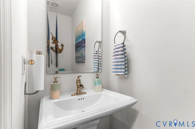 a hallway with wooden floor and some potted plants