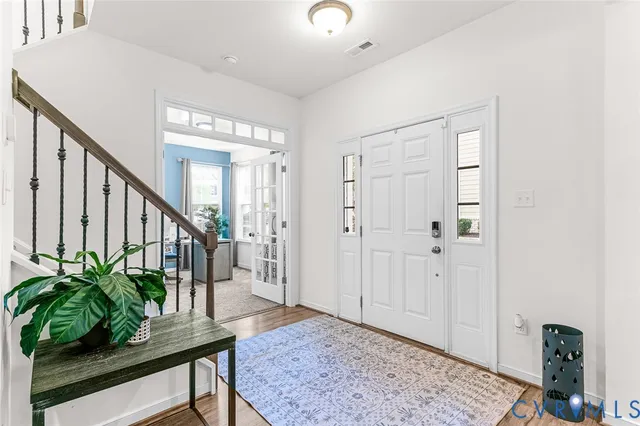 a view of an entryway with wooden floor