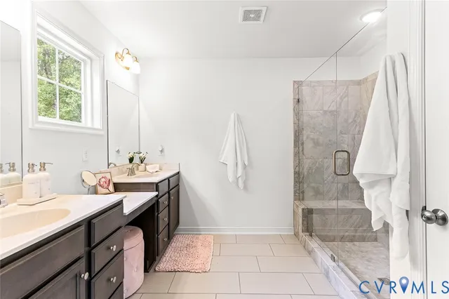a bathroom with a double vanity sink toilet and mirror