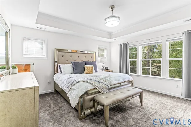 a bedroom with a large bed and a dresser