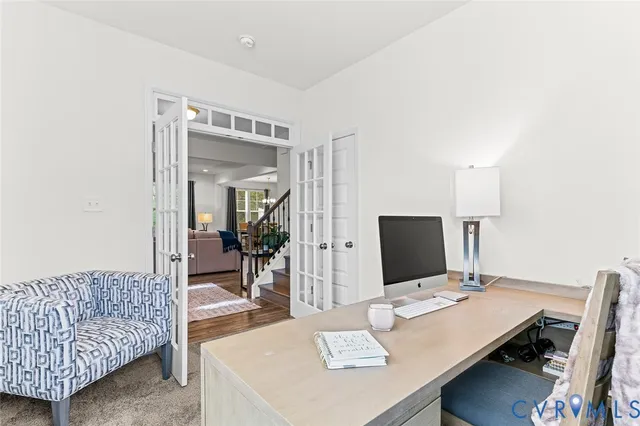 a living room with furniture fireplace and a large window
