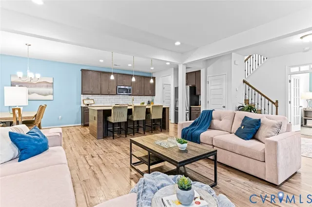 a kitchen with kitchen island a dining table and chairs