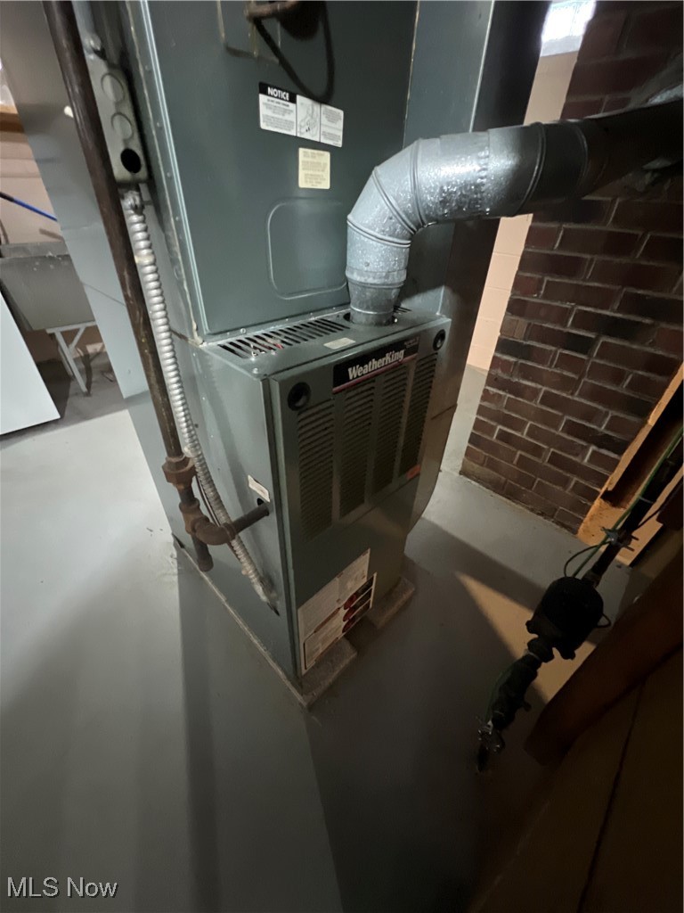 11406 Granger Road Cleveland, OH 44125 - Photo 24 of 28 Utility room featuring heating unit