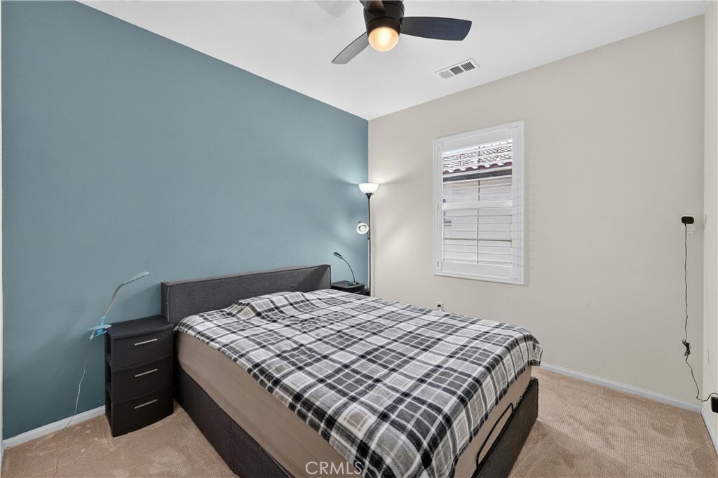 849 The Promenade, Unit D Azusa, CA 91702 - Photo 22 of 37 a bedroom with a bed and a window