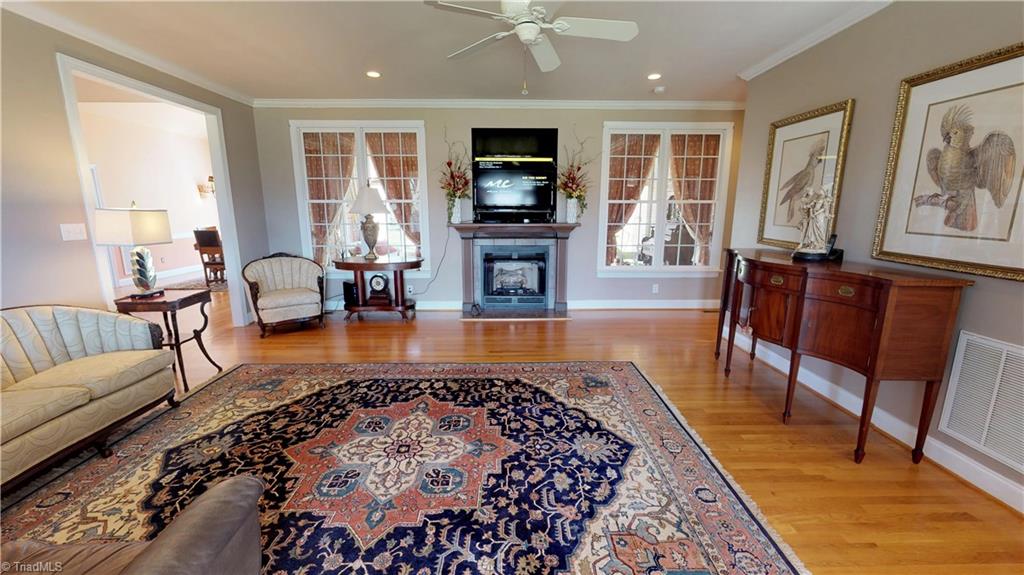 7857 Alcorn Road Oak Ridge, NC 27310 - Photo 8 of 28 Great Room with hardwood floors, gas log fireplace and Windows that look out to Sunroom in rear.