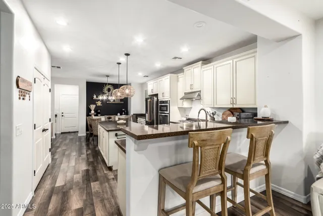 a kitchen with stainless steel appliances kitchen island granite countertop a sink and cabinets