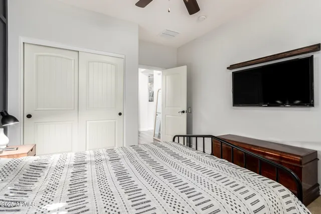 a bedroom with a bed and a flat screen tv