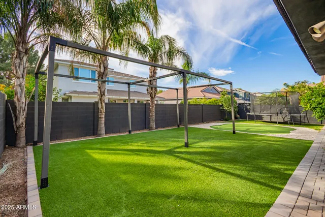 a view of a backyard with a garden and entertaining space