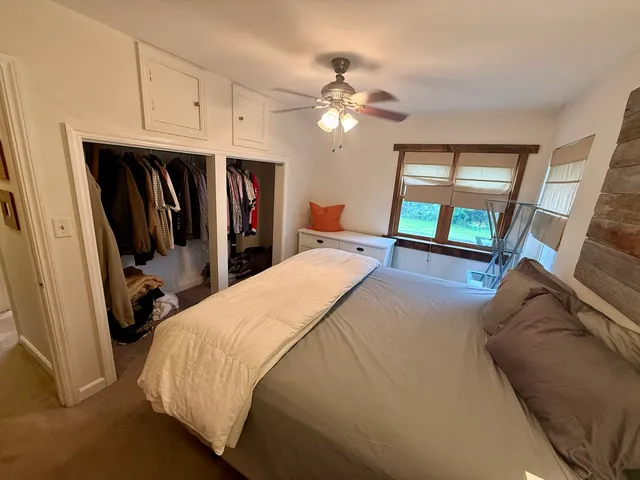 a bed room with a bed and a chandelier