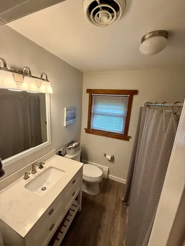 a bathroom with a sink mirror and toilet