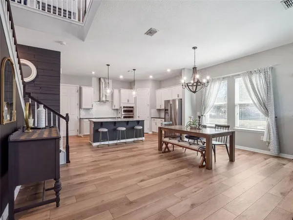 a living room with furniture a table and kitchen view