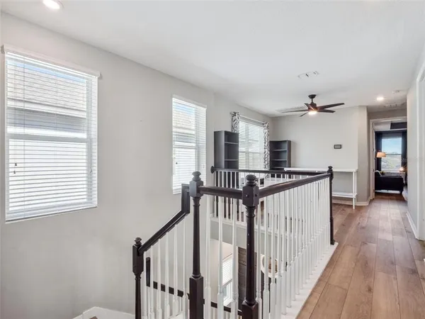 a bedroom with a bed a couch and a ceiling fan