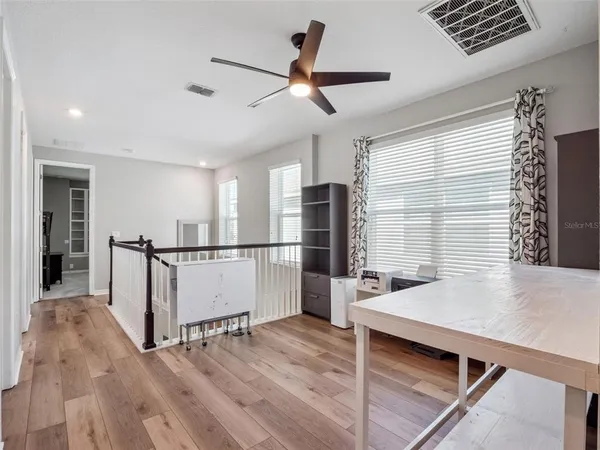 a bedroom with a bed a couch and a chandelier