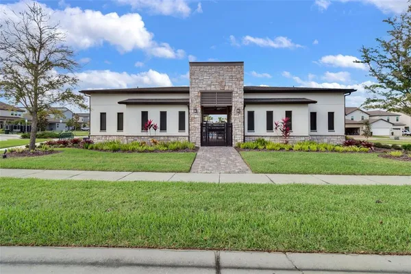 an aerial view of a swimming pool with outdoor seating and yard in back