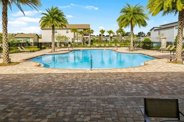 an aerial view of residential houses with outdoor space and swimming pool