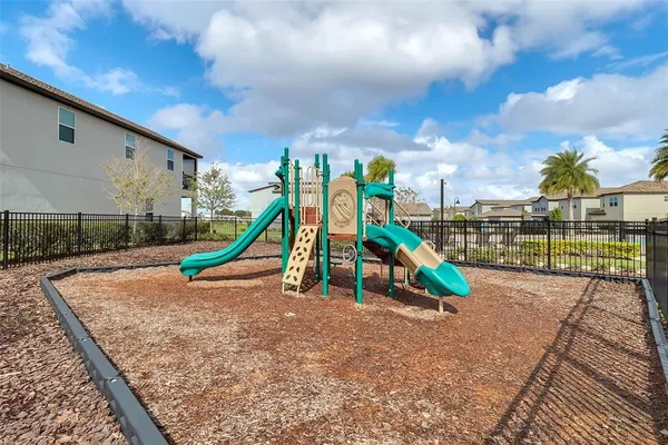 an aerial view of residential houses with outdoor space and lake view