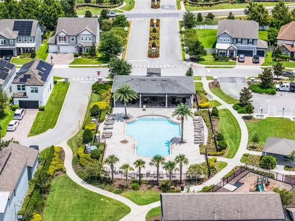 an aerial view of a house with garden space and lake view