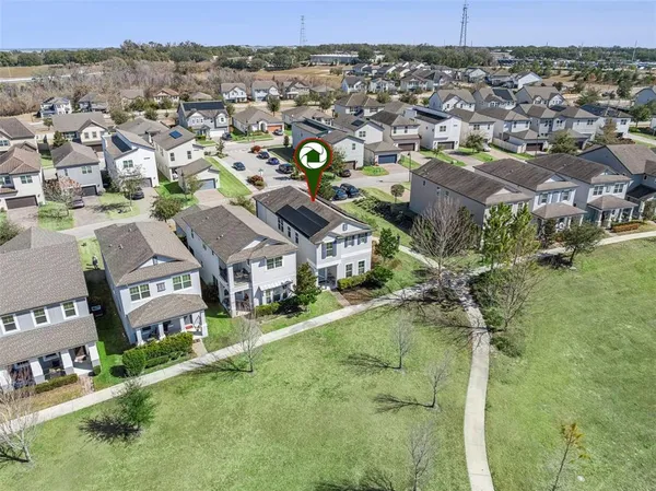 an aerial view of residential houses with outdoor space and city view