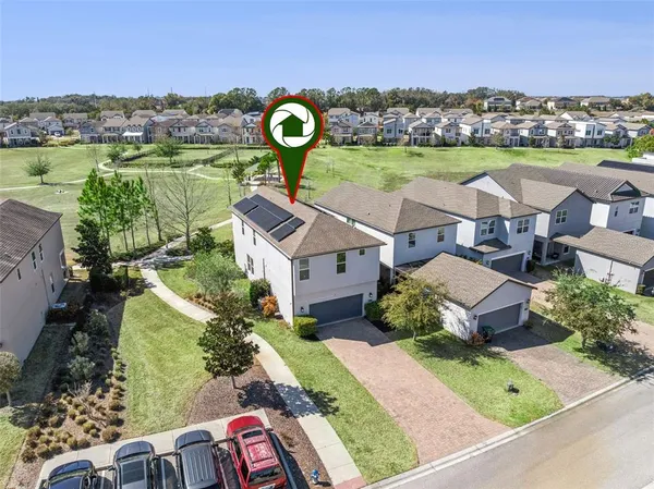 an aerial view of a house with garden space and outdoor seating