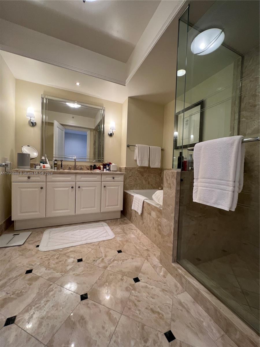 1435 Brickell Avenue, Unit 3307 Miami, FL 33131 - Photo 20 of 76 a large bathroom with a sink and a mirror