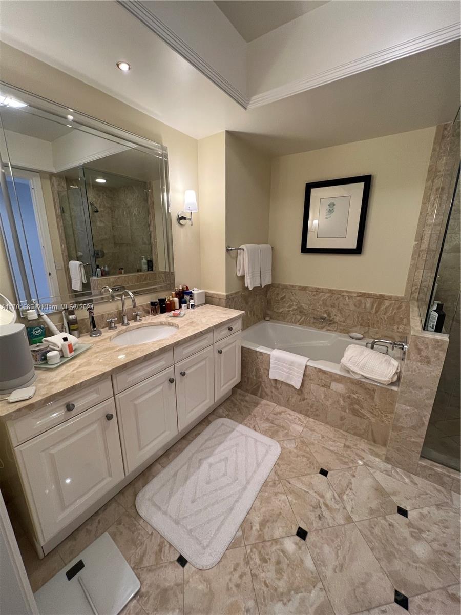 1435 Brickell Avenue, Unit 3307 Miami, FL 33131 - Photo 22 of 76 a spacious bathroom with a double vanity sink a mirror and a bathtub