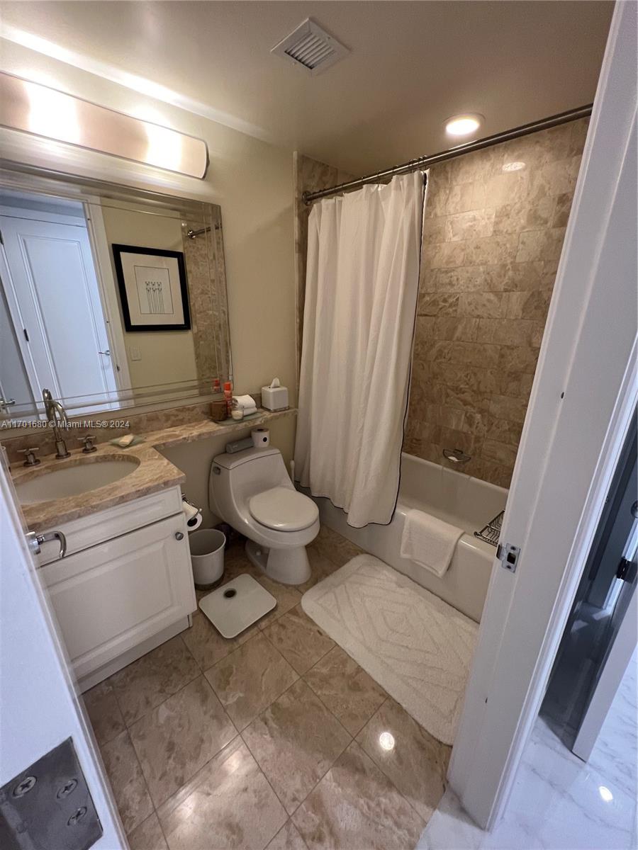 1435 Brickell Avenue, Unit 3307 Miami, FL 33131 - Photo 26 of 76 a bathroom with a granite countertop sink toilet and shower