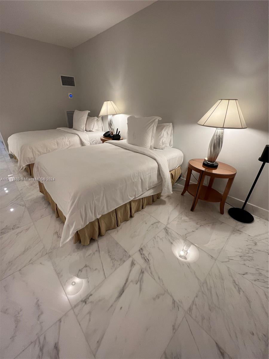 1435 Brickell Avenue, Unit 3307 Miami, FL 33131 - Photo 31 of 76 a bedroom with a bed and a lamp