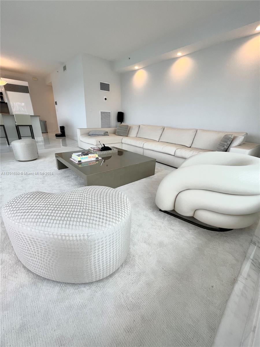 1435 Brickell Avenue, Unit 3307 Miami, FL 33131 - Photo 54 of 76 a living room with furniture and a wooden floor