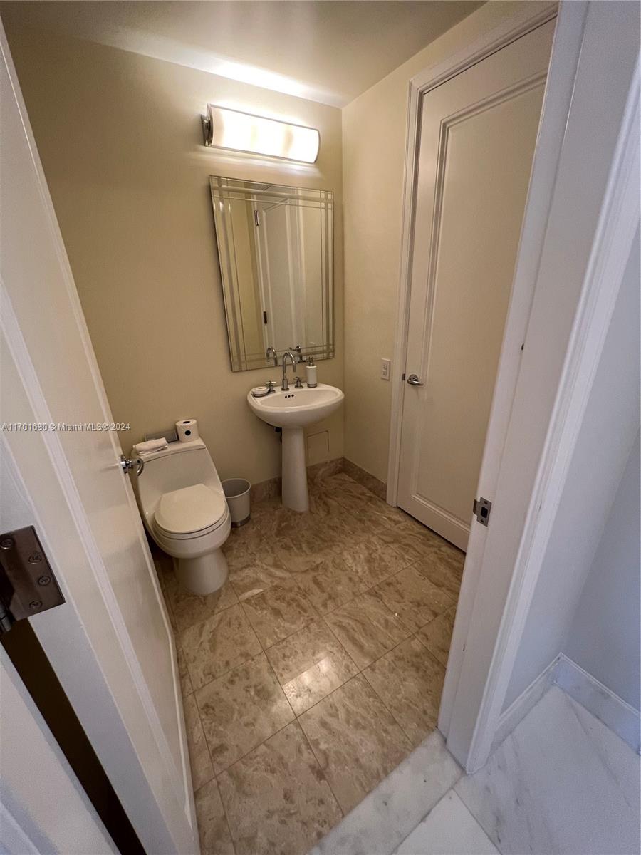 1435 Brickell Avenue, Unit 3307 Miami, FL 33131 - Photo 9 of 76 a bathroom with a sink toilet and shower