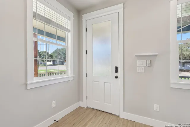 an empty room with wooden floor and a window