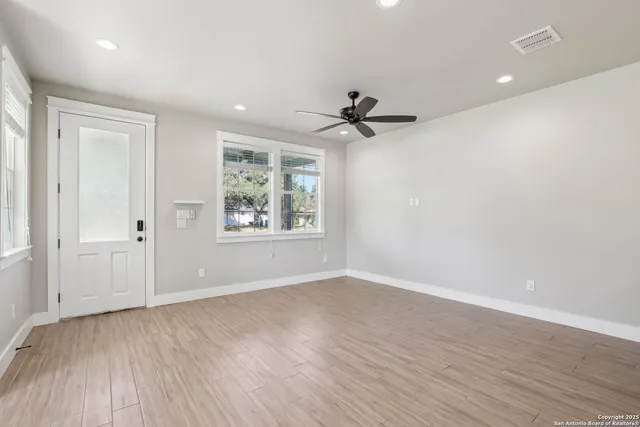 wooden floor in an empty room with a window