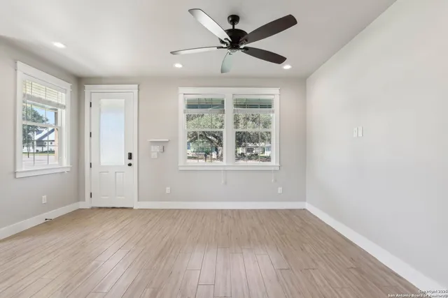 wooden floor in an empty room with a window