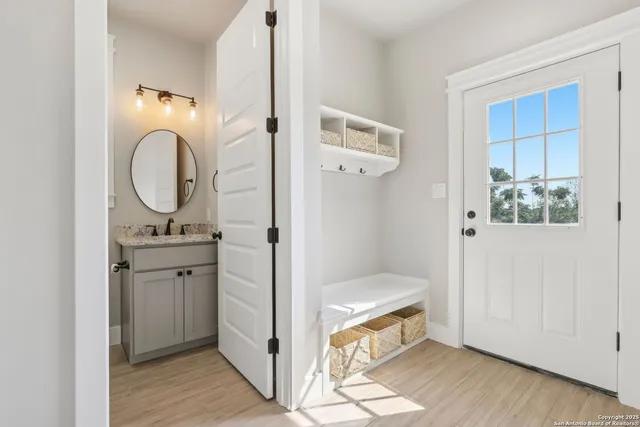 a bathroom with a sink mirror and vanity