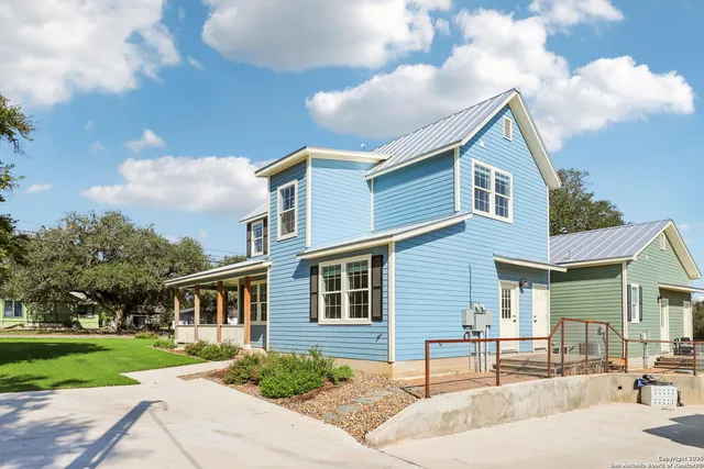 a front view of a house with garden and patio