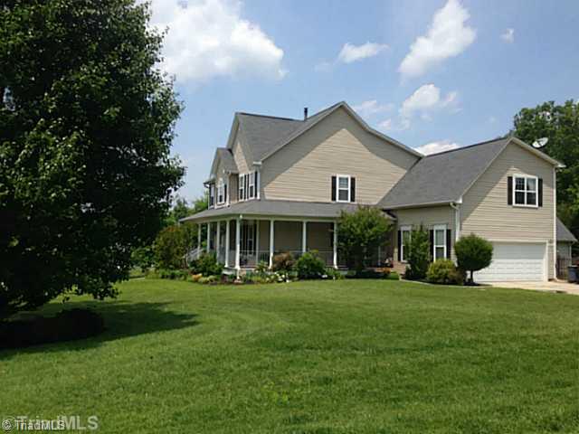 7834 Wilson Farm Road Summerfield, NC 27358 - Photo 2 of 16 Exterior Front. Side entry garage