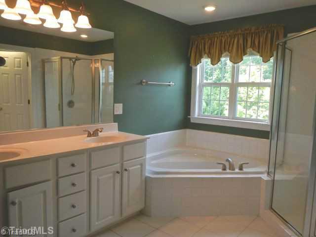7834 Wilson Farm Road Summerfield, NC 27358 - Photo 12 of 16 Exterior Front. Master bath with double vanity and door to closet