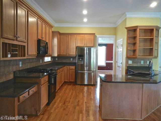 7834 Wilson Farm Road Summerfield, NC 27358 - Photo 3 of 16 Exterior Front. Kitchen with LED spot lights, underneath cabinet lighting, tons of cabinets and built-in desk. All appliances remain
