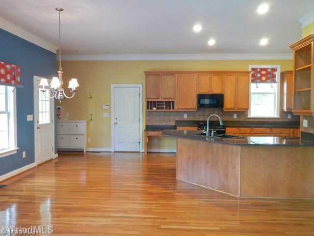 7834 Wilson Farm Road Summerfield, NC 27358 - Photo 4 of 16 Exterior Front. Breakfast area open to kitchen and Den