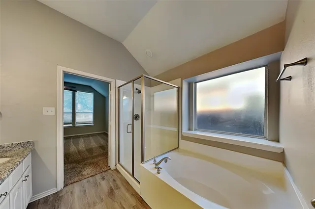 a bathroom with a bathtub and a shower