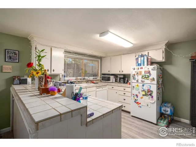 a kitchen view with appliances a stove and cabinets