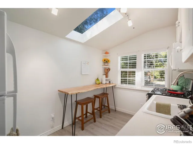 a bathroom with a sink a toilet and a shower curtain