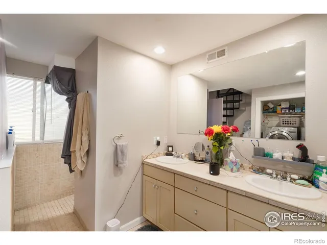 a bathroom with a sink mirror and vanity