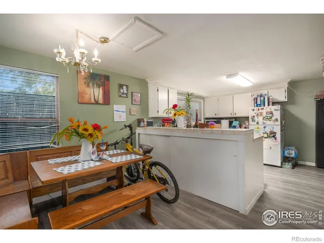 a view of a dining room with furniture and a chandelier