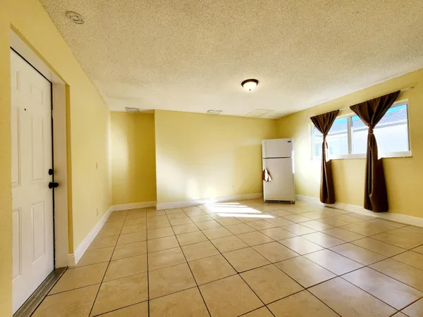 a view of a livingroom with a fireplace and window