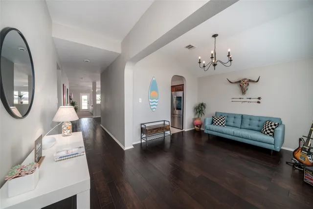a living room with furniture and a wooden floor