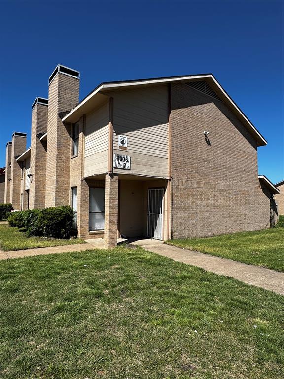 8005 Rothington Road, Unit 17 Dallas, TX 75227 - Photo 4 of 15 a front view of a house with a yard