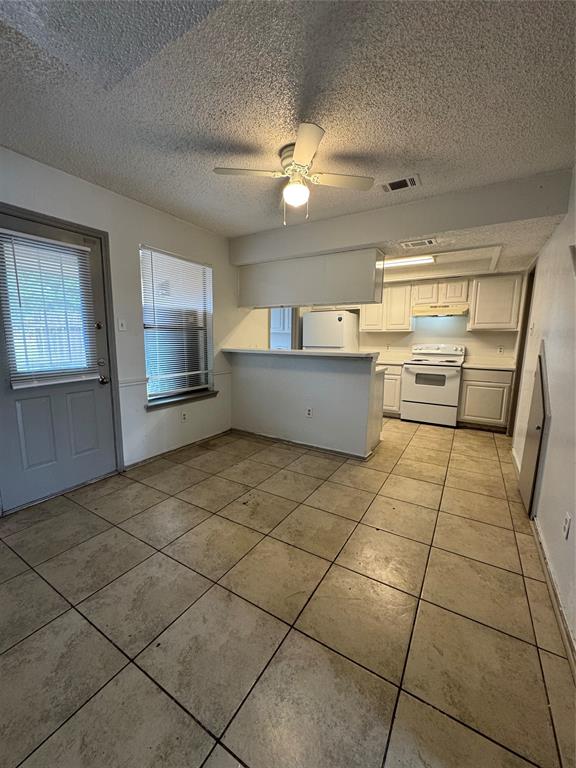 8005 Rothington Road, Unit 17 Dallas, TX 75227 - Photo 7 of 15 a kitchen with stainless steel appliances a sink and cabinets