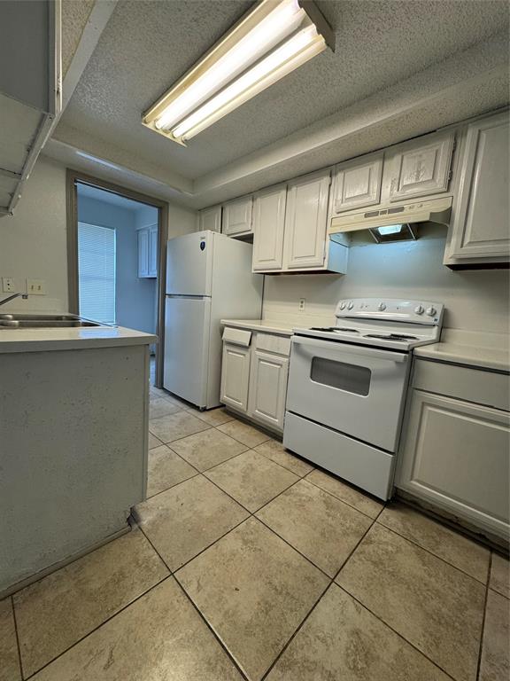 8005 Rothington Road, Unit 17 Dallas, TX 75227 - Photo 8 of 15 a kitchen with stainless steel appliances granite countertop a sink stove and cabinets